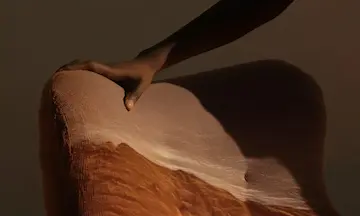 A person resting their hand on a couch